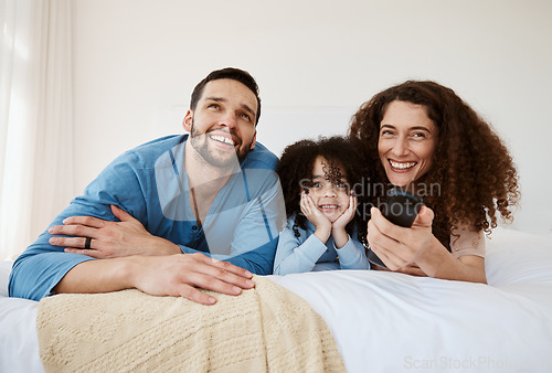 Image of Bedroom, happy family child and parents watching tv series, movie or streaming online video, cinema or theatre together. Bed, home and relax mom, dad and kid watch cartoon show, television or film