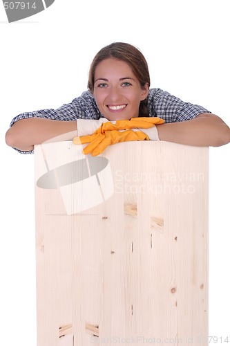 Image of woman carpenter holding wooden plank