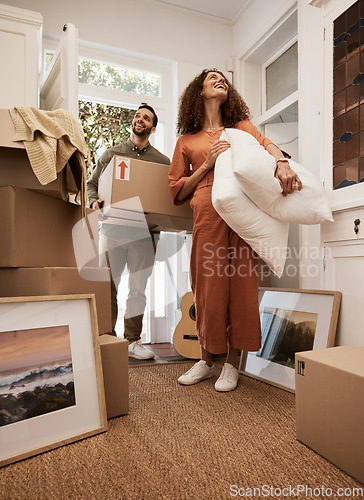 Image of Real estate, success and couple smile in a living room for moving, dream and home, relocation or mortgage. Property, investment and happy man with woman in new house with box, furniture and excited