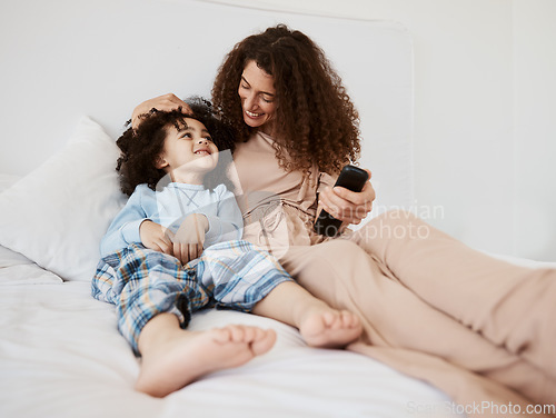 Image of Bed, happy family child and mom watching tv series, movie and bonding with son, connect and enjoy relax morning. Bedroom, kid and home mother watch cartoon show, television or media entertainment