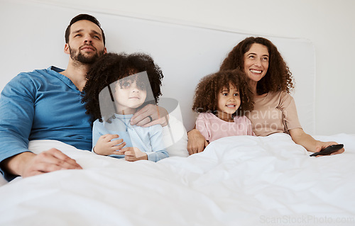 Image of Bedroom, kids and parents watch television series, subscription movies or streaming morning video, media or entertainment. Home bed, relax family or happy mother, father and children watching tv show