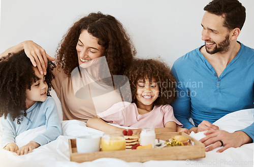 Image of Parents, children and breakfast in bed, morning or excited for love, bonding or care on holiday. Mother, father and kids in bedroom, food and smile together for nutrition, eating or happy family home