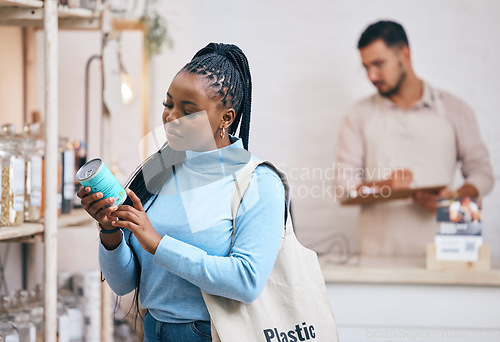 Image of Shopping, grocery store and black woman by shelf for choice, options and service in eco friendly supermarket. Small business, organic shop and customer reading label for groceries, products and food