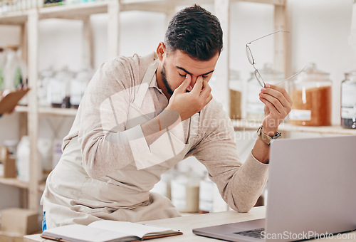 Image of Store, laptop and man with a headache, stress and burnout with financial crisis, tired and overworked. Fatigue, entrepreneur and business owner with a pc, migraine and online shop management fail