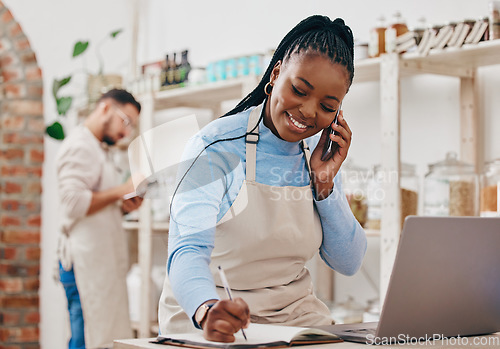 Image of Black woman, cashier notes and phone call with networking and inventory check for retail store. Happy, shop management and mobile with communication and discussion about business and supply chain