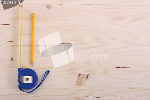 Image of wooden plank and measuring tape 