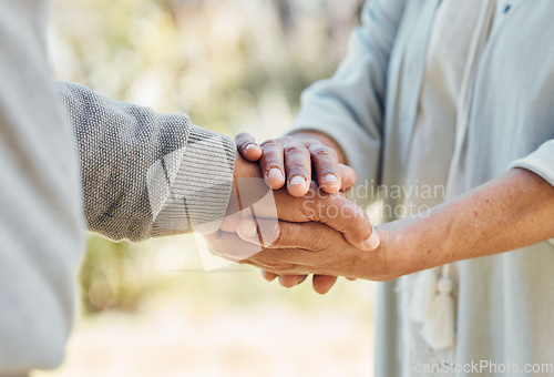 Image of Senior couple, holding hands and love with support in outdoor, nature or bonding in backyard with care, comfort or kindness. Helping, hand and people in retirement together with empathy and trust