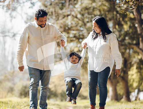 Image of Outdoor, parents and kid holding hands, love and fun with bonding, weekend break and walking. Happy family, mother and father with child, playful or adventure in a park, freedom and swing with energy