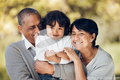 Image of Family, portrait and hug by child and grandparents in a park with care, bond and fun on blurred background. Love, smile and face of senior people embrace retirement freedom with kid in a forest