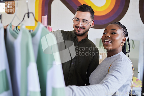 Image of Retail, store and interracial couple shopping for fashion or style together in a mall and happy for clothes. Customer, man and woman on a date for bonding on vacation or holiday and purchase outfit