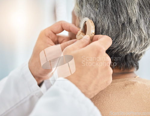 Image of Hearing aid, senior patient and doctor hand with consultation and medical device. Healthcare, deaf and person with a disability in clinic for solution and professional care in a hospital for support