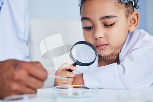 Image of Child, science and girl with a magnifying glass in laboratory learning, research or curious to study chemistry in education. Kid, scientist and check with a magnifier on experiment, test or analysis