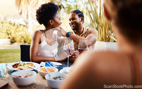 Image of Outdoor lunch, friends and happy black couple, woman and man wipe, cleaning and remove food from African girlfriend. Together, reunion and people bonding, smile and enjoy meal, buffet or brunch