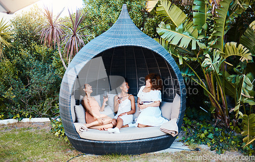 Image of Travel, luxury and happy women on vacation talking in a conversation or friends on an outdoor getaway together. Wine, laughing and people on holiday in nature bonding in happiness in a modern tent