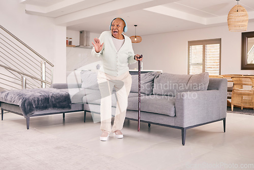 Image of Living room, dancing and happy senior woman with headphones enjoy music and excited for retirement in her home. Happiness, freedom and elderly person listening to radio, audio and song with smile