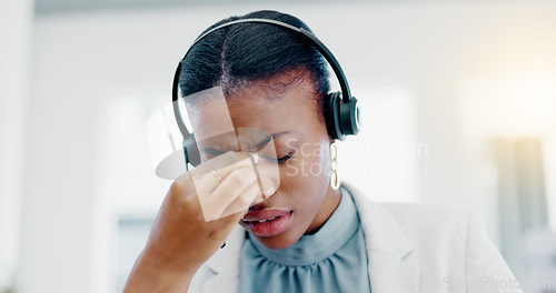 Image of Black woman, call center and headache in stress, burnout or anxiety from strain at the office. African American female consultant suffering head pain, ache or sore eyes feeling overworked or stressed