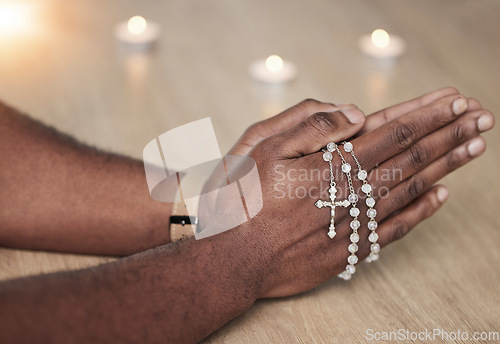 Image of Rosary, man hand and cross prayer beads in a home with hope, christian praise and religion. Praying, necklace and worship in a house with god, gratitude and spiritual guide for support and healing