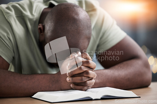 Image of Bible, hands and praying man with book and religion study at home for worship and spiritual support. Faith, christian knowledge and person with gratitude, scripture education and guidance in a house