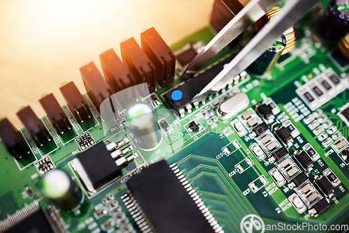 Image of Motherboard, microchip tweezer and engineering closeup with electric maintenance of circuit board. Developer, IT and dashboard for electrical hardware and technician tools for information technology