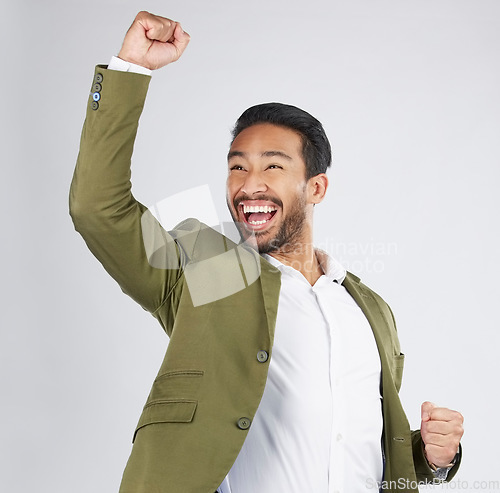 Image of Happy asian man, fist pump and celebration in winning, success or promotion against a white studio background. Excited businessman smile in happiness for bonus, good news or victory with mockup space