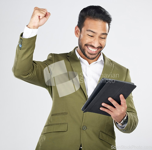 Image of Business man, winner and success on tablet for stock market, trading news or results, profit and sales in studio. Excited professional person for digital trading with fist and yes on white background