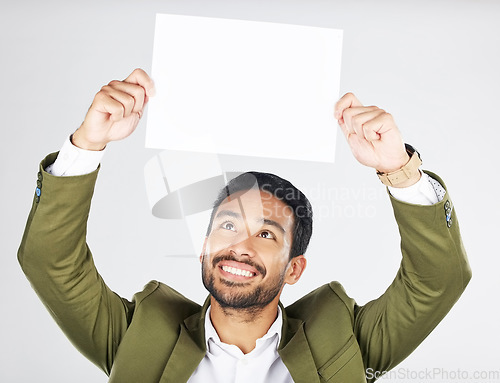 Image of Happy asian man, billboard and sign for advertising, marketing or branding against a white studio background. Businessman smile with paper, poster or idea for message or advertisement on mockup space