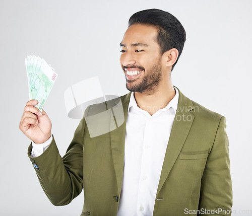 Image of Happy asian man, money and finance in savings, investment or loan against a white studio background. Excited businessman smile and cash or dollar bills in financial freedom, profit or salary increase