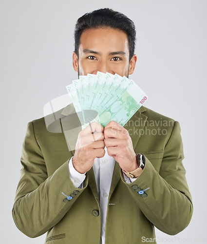 Image of Asian man, money fan and finance in savings, investment or loan against a white studio background. Portrait of businessman with cash or dollar bills in financial freedom, profit or salary increase