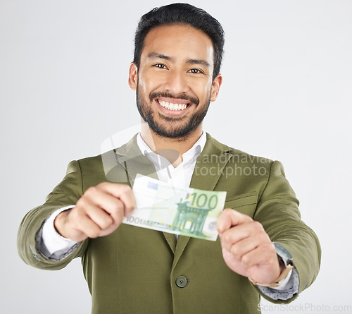 Image of Happy asian man, portrait and money in finance, savings or investment loan against a white studio background. Businessman smile with cash, euro or bill in financial freedom, profit or salary increase