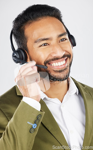 Image of Happy asian man, call center and headphones in customer service, support or telemarketing against a white studio background. Friendly businessman, consultant or agent smile in online advice or help