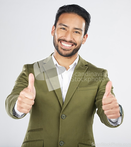 Image of Happy asian man, portrait and thumbs up in thank you, winning or success against a white studio background. Businessman smile with like emoji, yes sign or OK in agreement, good job or approval