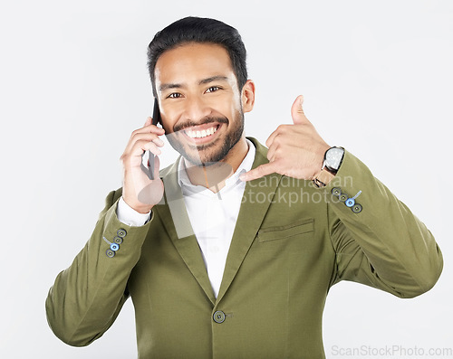 Image of Phone call, hand gesture and portrait of business man in studio for conversation, chat and communication. Networking, shaka sign and professional person on smartphone for deal on white background