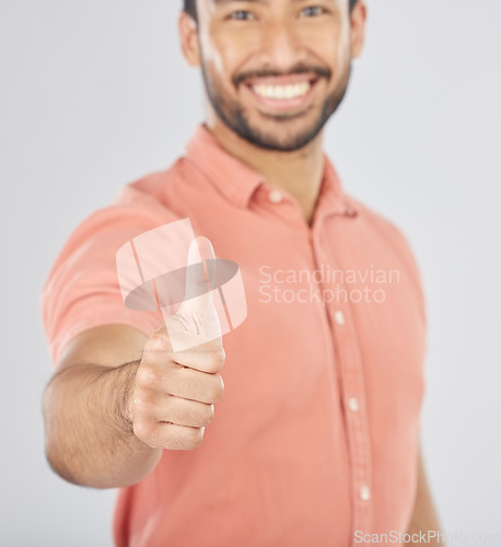 Image of Happy asian man, portrait and thumbs up in success, winning or good job against a white studio background. Male person smile with like emoji, yes sign or OK in agreement, thank you or approval