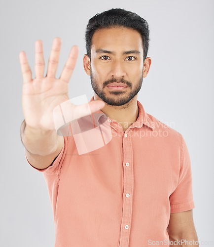 Image of Stop, hand and portrait of asian man in studio with warning, control or protection order on grey background. Protest, palm and face of Japanese male model with no, emoji and limit, ban or threat sign