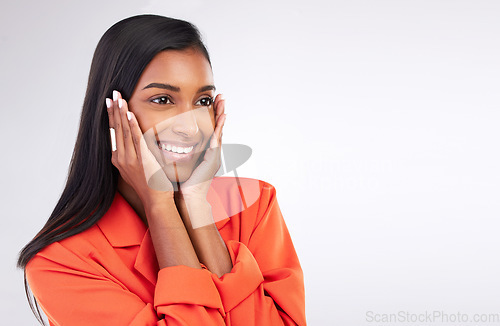 Image of Smile, excited and hands on woman face in studio shy for news, promo or announcement on white background. Happy, emoji and Indian female model with gossip, gesture or cute reaction while isolated