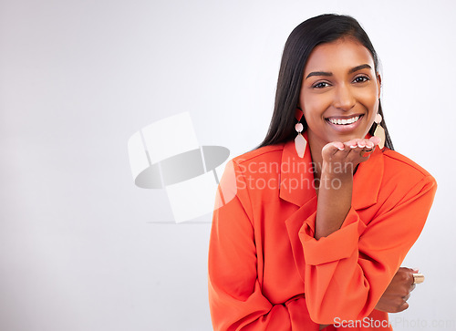 Image of Smile, portrait and Indian woman blowing kiss in studio for flirting, care or romance gesture on grey background. Happy, face and female model with hand kissing emoji for thank you, gratitude or love