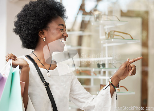 Image of Customer, shopping and black woman with a choice, sale and retail with luxury, optometry store and happiness. Client, shopper and African person buying glasses, discount deal and decision with spree