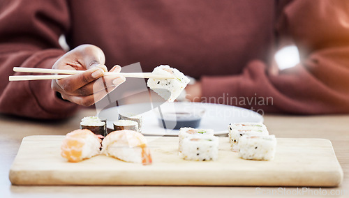Image of Sushi, seafood and brunch with hands of person in store for restaurant, Japanese cuisine and menu. Fish, salmon and health with closeup of customer eating for nutrition, Asian diet and fine dining