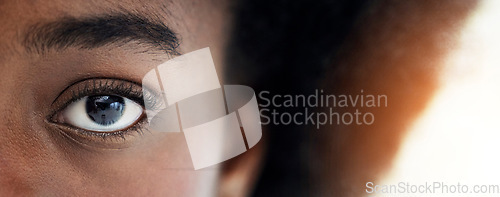 Image of Eyes, closeup and portrait of African woman with mockup space for focus, thinking and vision. Banner, lens flare and zoom of half face of person looking for perception, awareness and intense stare