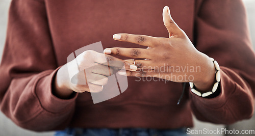 Image of Wedding ring, hands and woman with divorce, decision and relationship doubt in her home. Jewelry, finger and female with marriage anxiety, commitment or fail in living room for choice regret in house