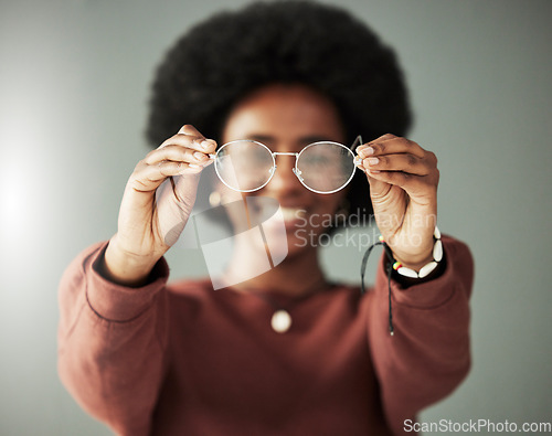 Image of Hands, woman and closeup of glasses for vision, eyesight and prescription eye care in studio. Person with optical frame, lens choice and eyewear fashion for test, healthcare assessment and optometry