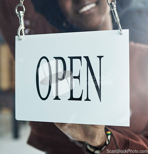 Image of Store, window or open sign by happy person for small business, startup or restaurant poster advertising. Coffee shop, notice or manager by glass billboard news for cafe, service or entrepreneurship