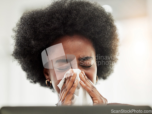 Image of Allergies, sneeze and sick black woman blowing nose in home office with allergies, flu or cold in her home. Tissue, paper and African female freelancer with virus, hayfever or covid working on laptop