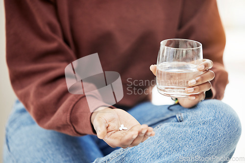 Image of Closeup, water and woman with pills, medicine and nutrition supplements with wellness, vitamins and health. Zoom, person or girl with a glass, tablets and medication for virus with treatment or drugs