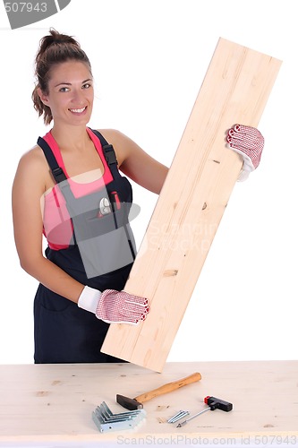 Image of woman carpenter holding wooden plank 