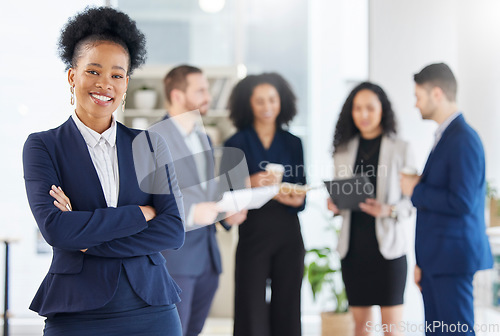 Image of Crossed arms, leadership and portrait of professional black woman in the office with confidence. Happy, smile and young African female attorney with a team of lawyers for legal project in workplace.