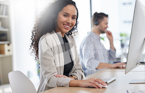 Image of Portrait, woman and smile at computer in call center for customer service, advisory questions and CRM in coworking agency. Happy consultant working help desk for telecom support, FAQ contact or sales