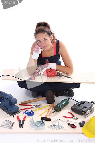 Image of woman carpenter with work tools 