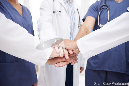 Image of Doctor, teamwork and hands together in meeting, motivation or unity in healthcare mission together at hospital. Closeup of professional medical group piling in team building, support or clinic goals