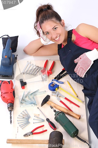 Image of woman carpenter with work tools 
